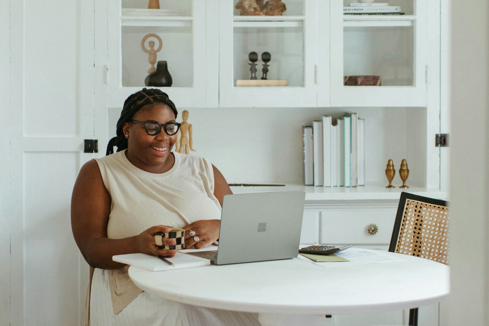 Woman business owner reviewing plans at her desk — Service Professionals industry